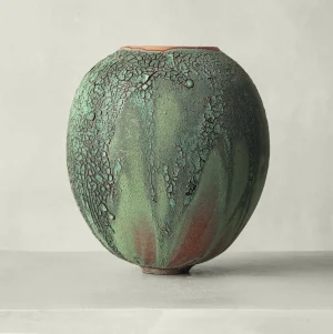 ceramic vase, with rich green tones and oxidized textures, recalls mossy stone and earth, organic design piece rooted in quiet strength, handmade by Karen Swami, atelier in France