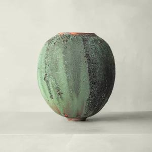 A handcrafted artisan vase, layered green and deep black textures, earth-inspired ceramic piece, brings organic depth to refined home decor, unique decoration