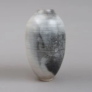 handmade French ceramic vase, showcases a minimalist palette of soft grey and deep charcoal, capturing the essence of naked clay and the purity of artisan ceramic design, refined piece of luxury pottery, adds quiet strength to any space, an unique piece of gift, handmade art piece in Paris